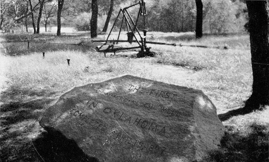 Vintage postcard shows large rock with the words, THE FIRST COMMERCIAL OIL WELL IN OKLAHOMA COMPLETED APRIL 15, 1897. Bartlesville, Oklahoma.