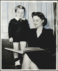 Helen Prichard, reading a book to her son, Lev H. Prichard, III - 1941